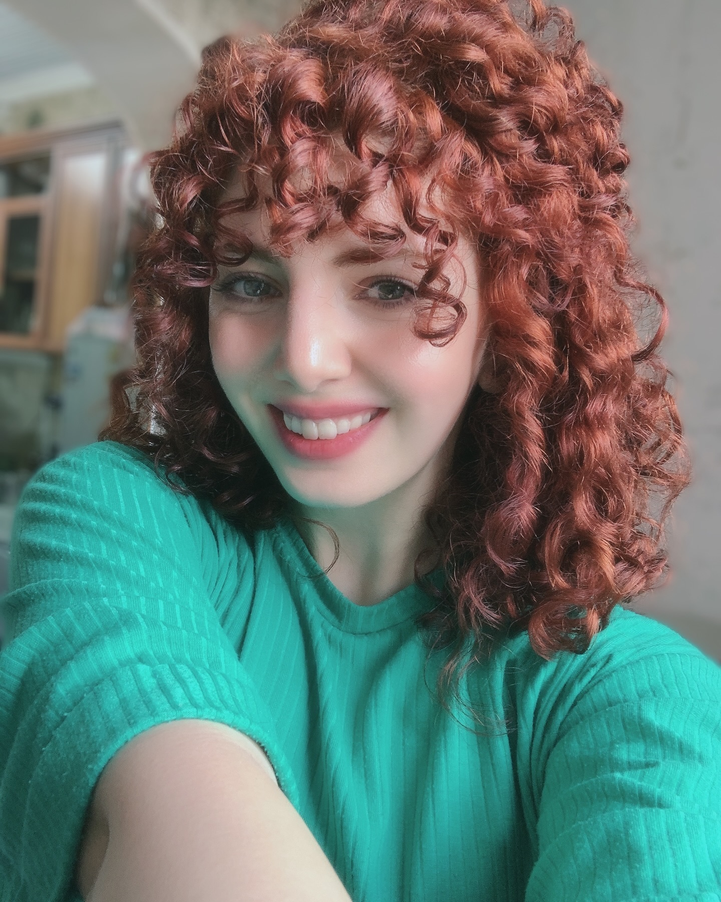 23. Radiant Ringlets: the Fiery Curly Bob with Flirty Bangs