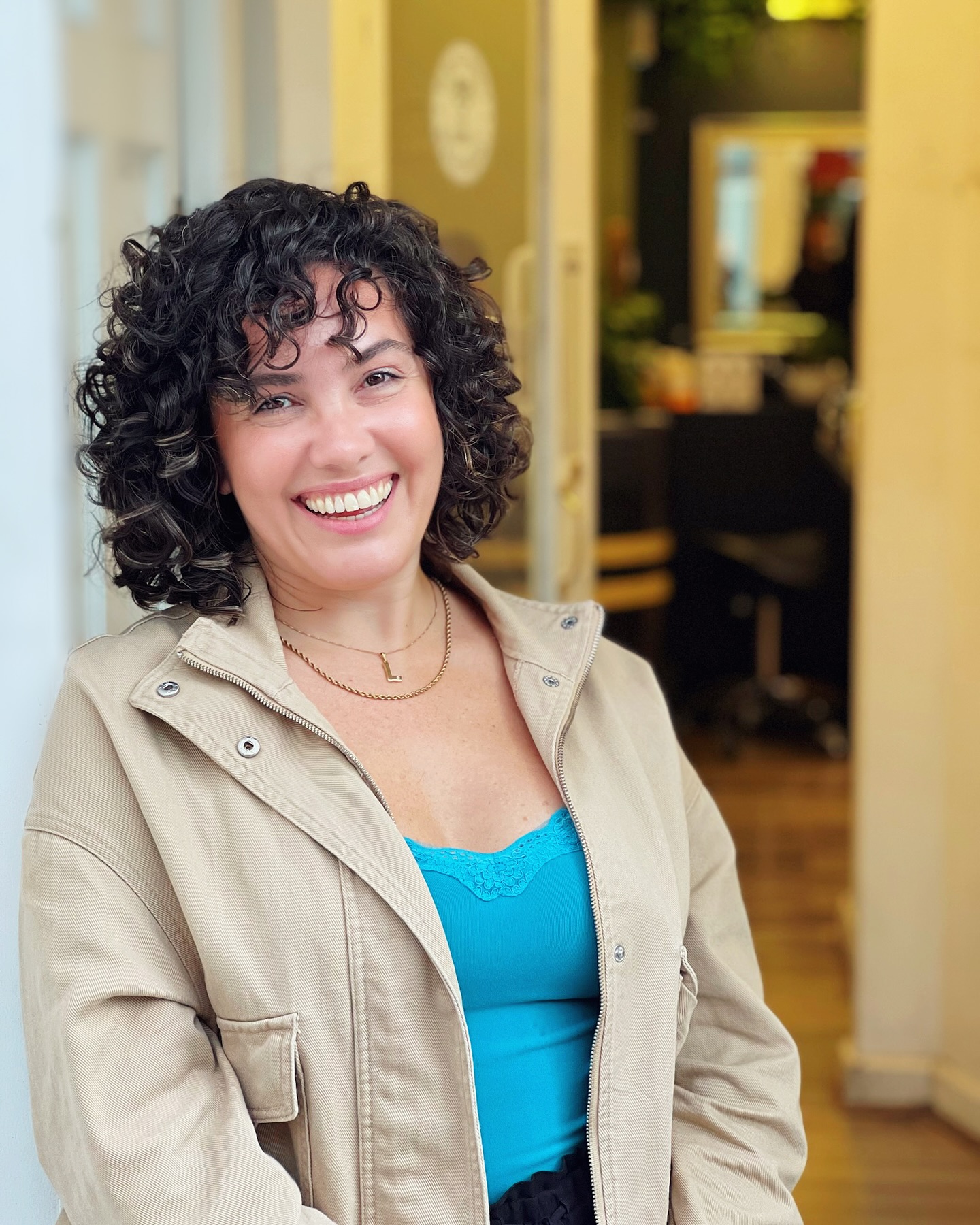 11. Effortlessly Radiant: Embrace the Playful Charm Of Curly Bangs