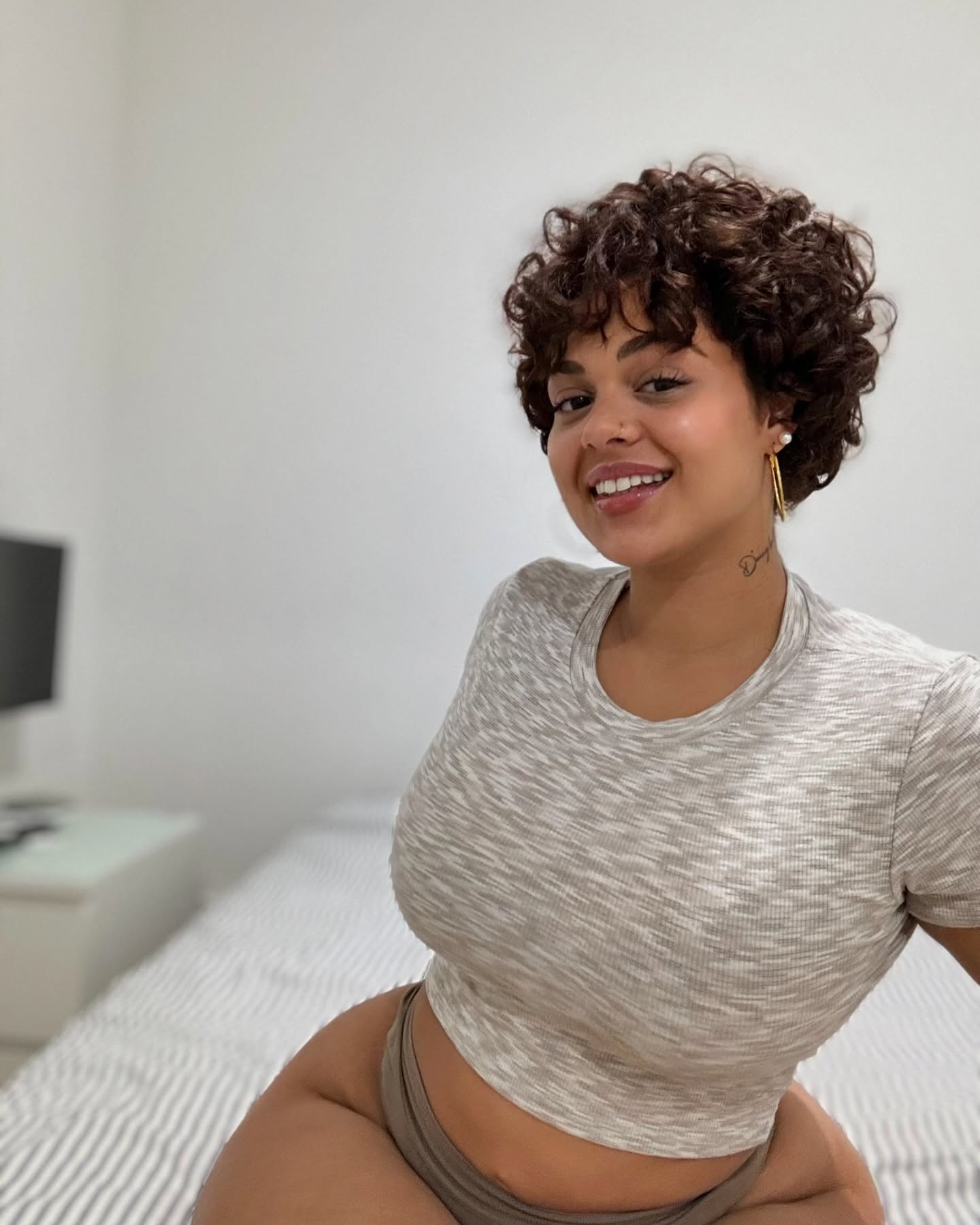 21. Curls Embracing Confidence: the Playful Choppy Bangs Revolution