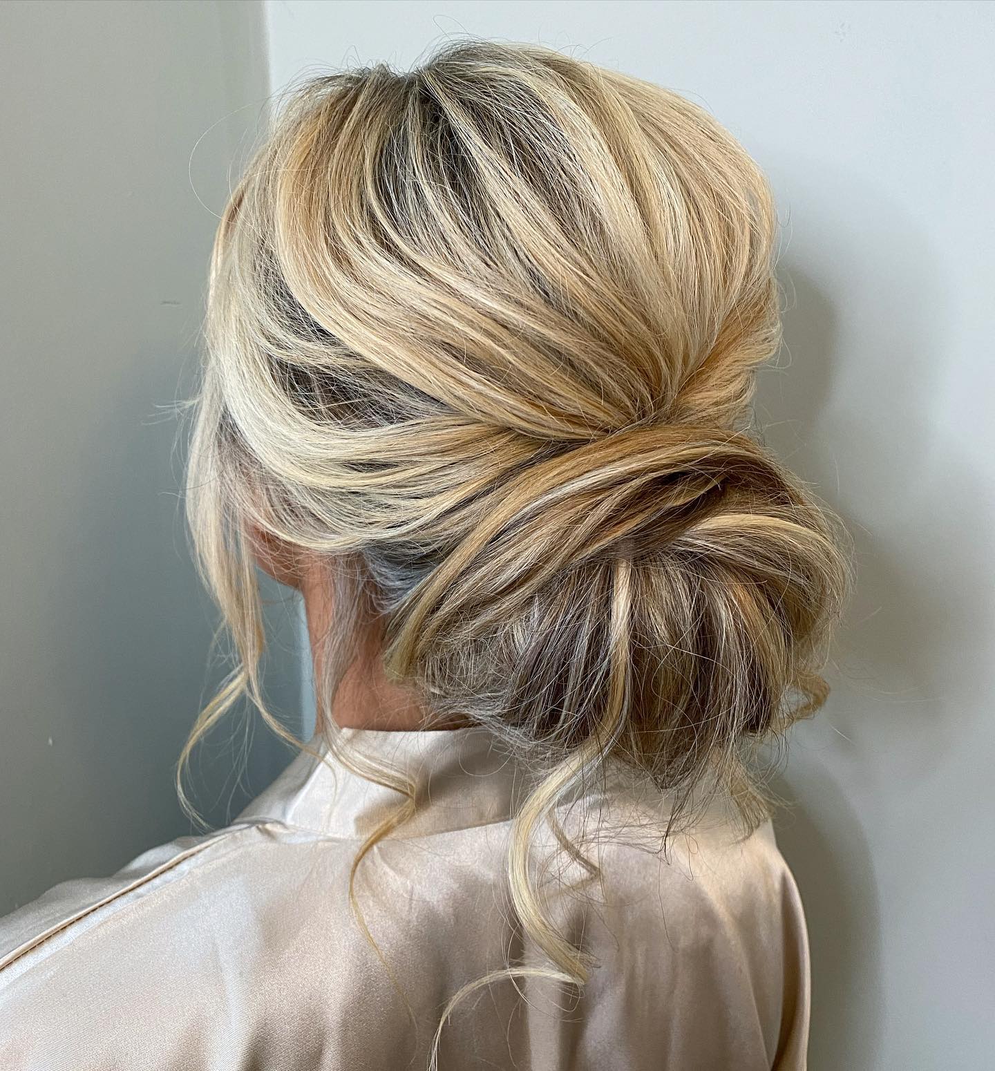 21. Effortlessly Romantic Twisted Bun with Whispered Tendrils