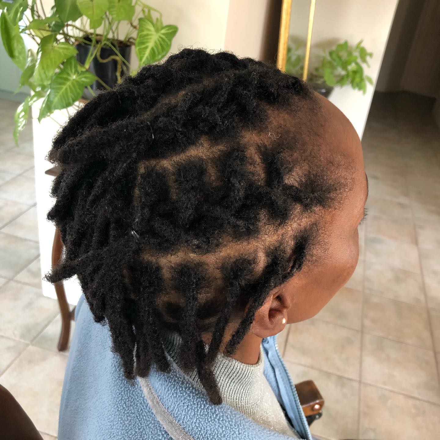 34. Roots Of Artistry: Sculptural Short Locs with Intricate Parting