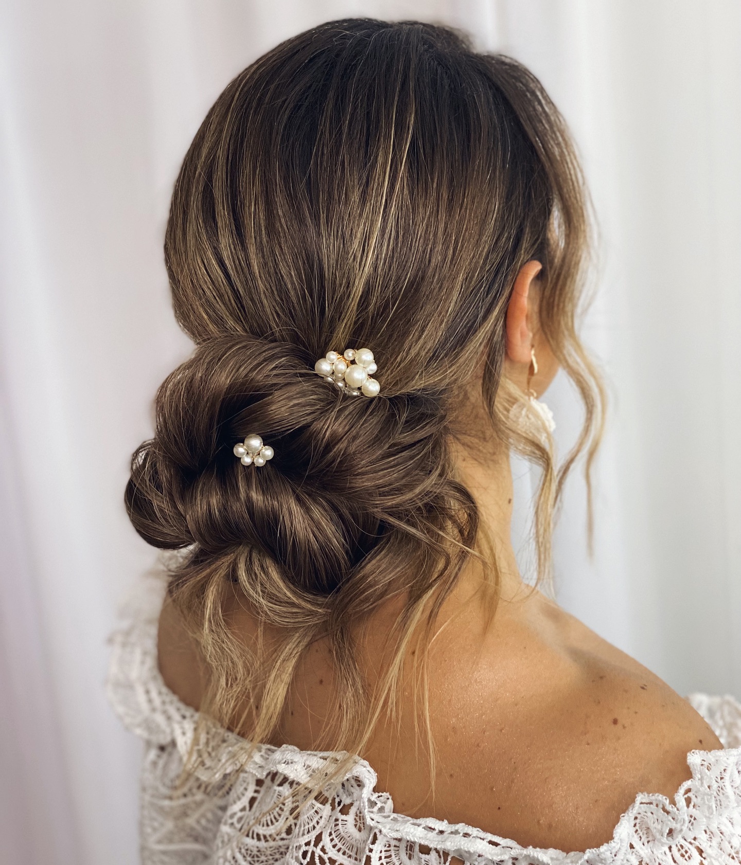 16. Whimsical Elegance: a Twisted Bun Adorned with Pearls