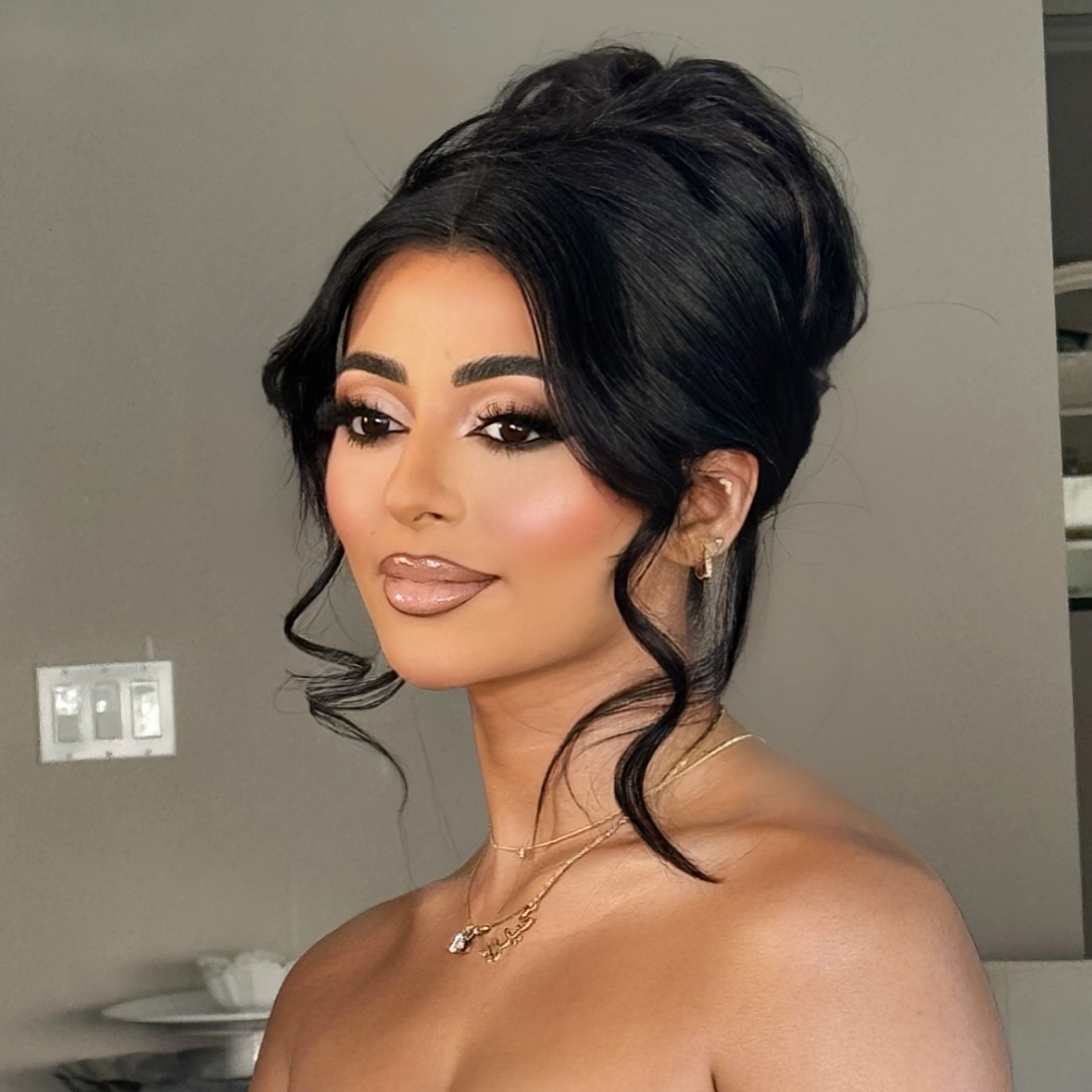 24. Chic Elevation: the Glamorous Bouffant Twist with Playful Tendrils