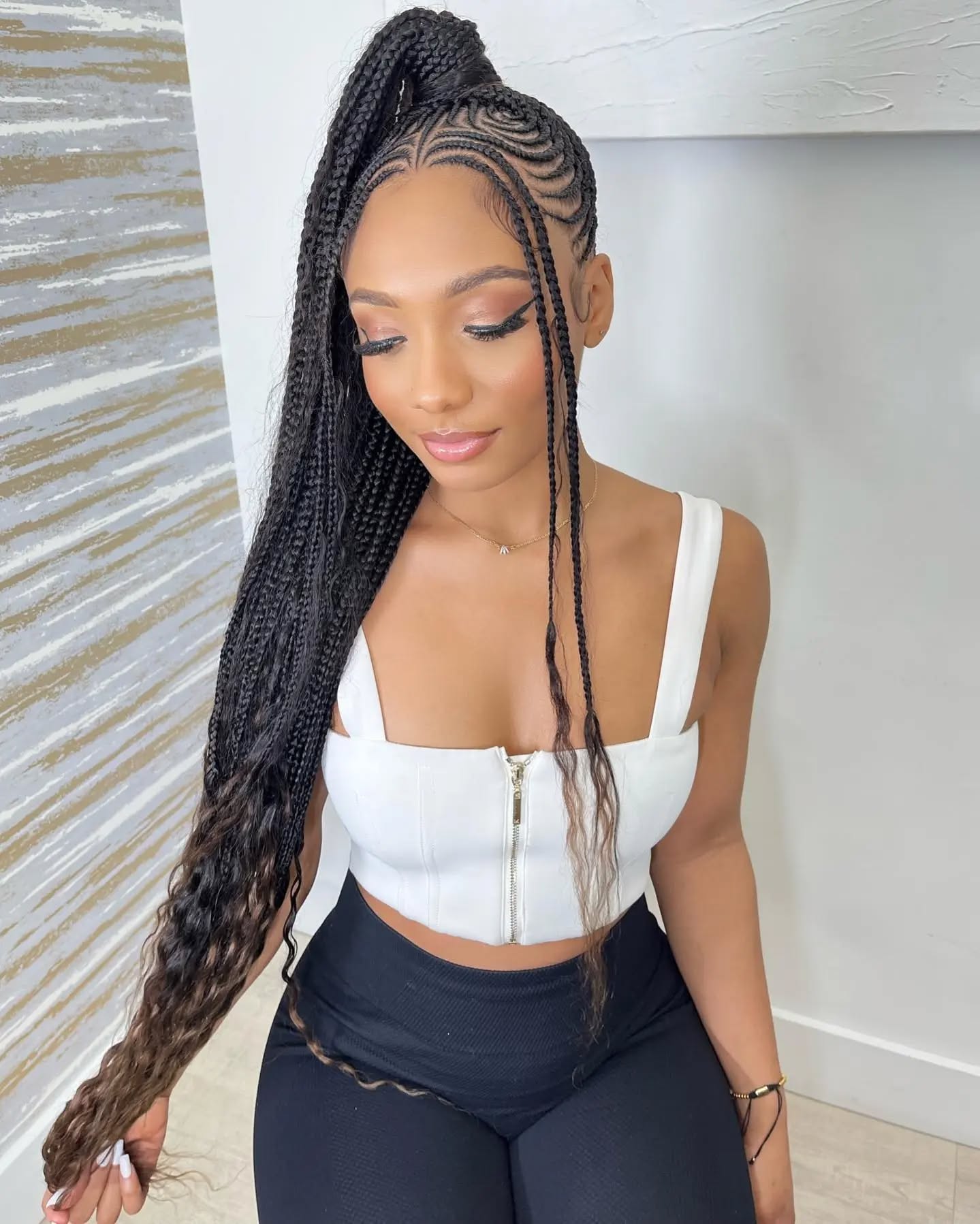 33. Sleek and Chic: a High-drama Box Braid Ponytail with Intricate Cornrow Accents