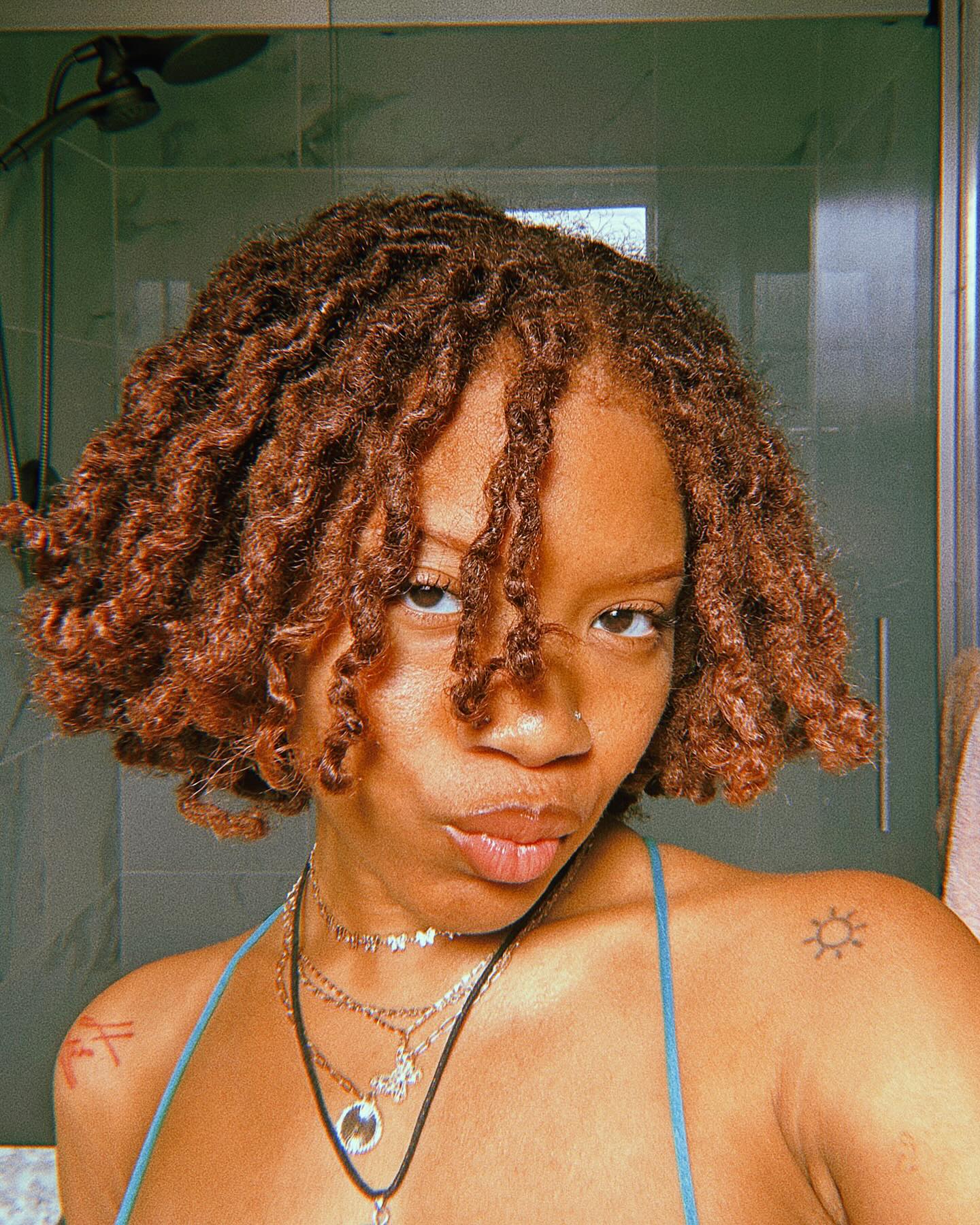 5. Twisted Radiance: Short Locs with a Playful Pop