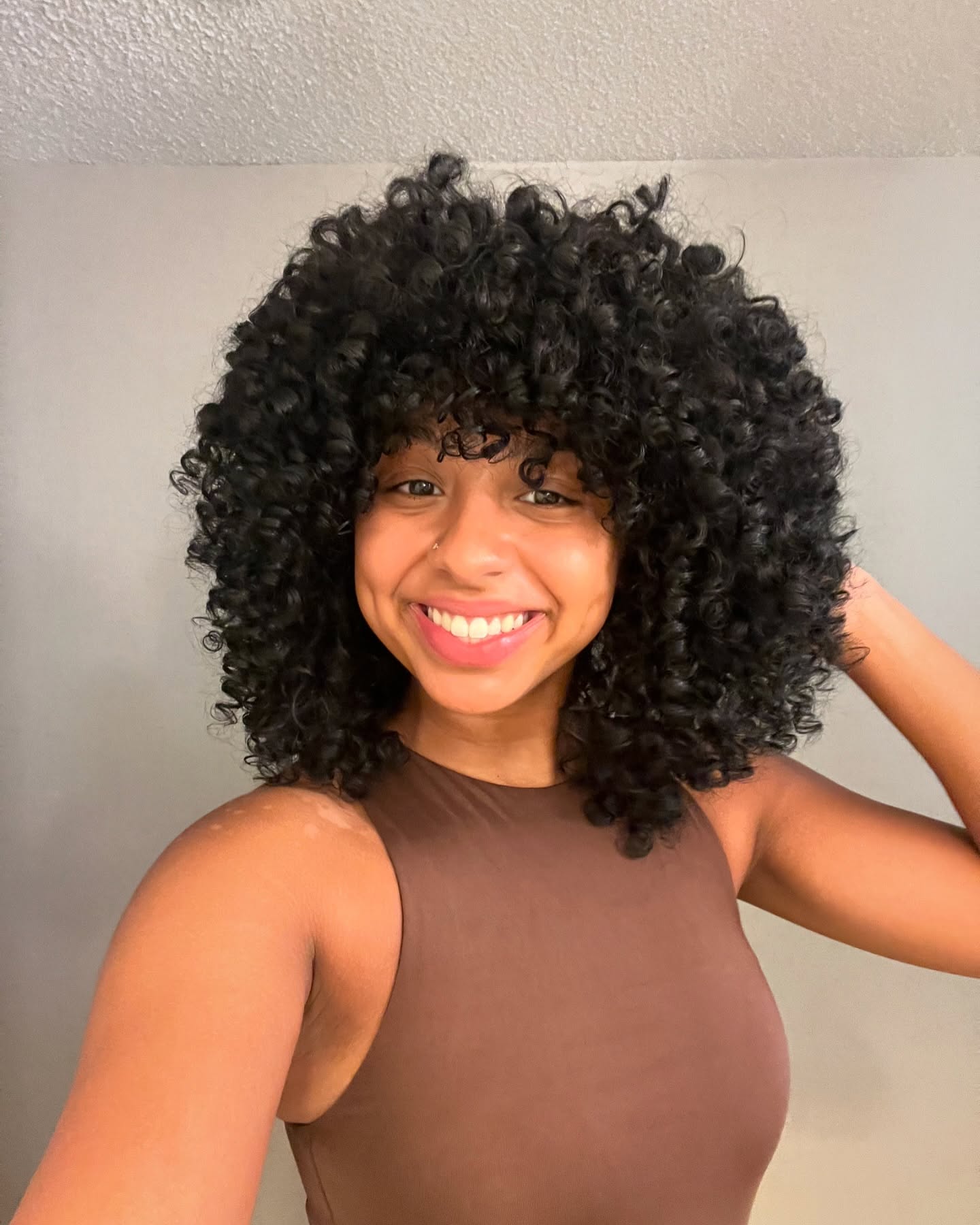 1. Crowning Glory: Embracing Bold, Bouncy Curly Bangs