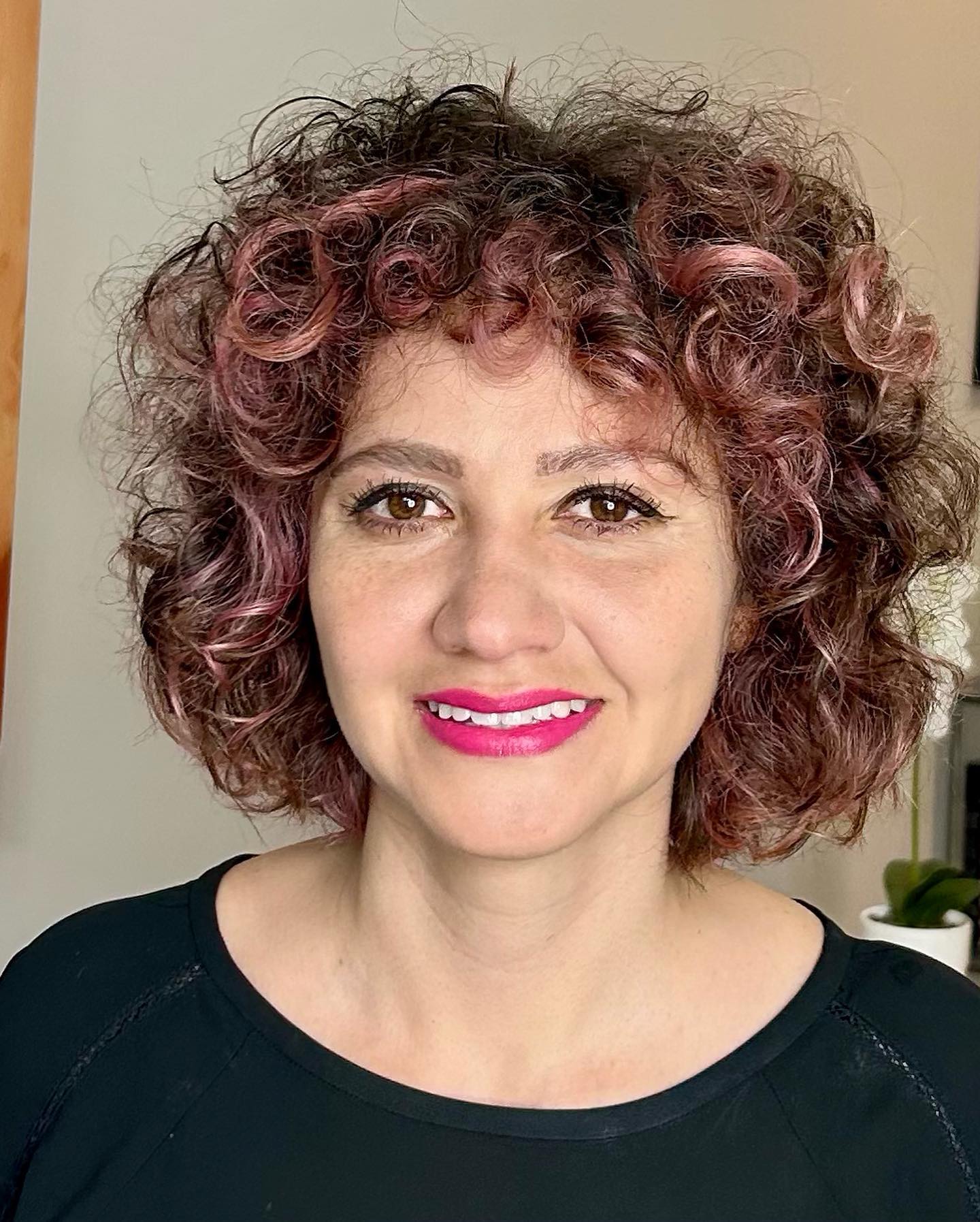 15. Curly Elegance with a Pop Of Pink