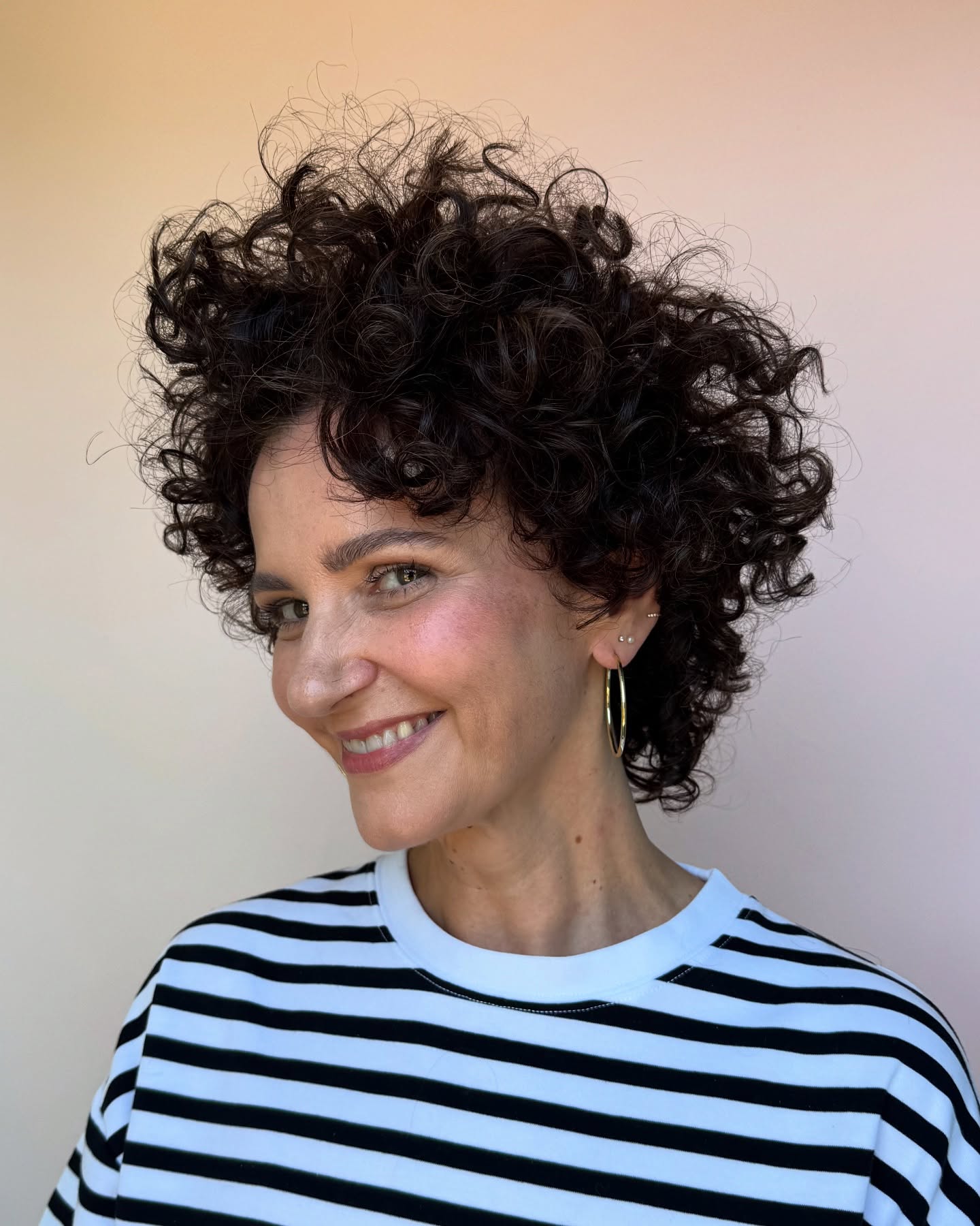 44. Urban Bounce: the Playful Curly Cut with Chic Bangs