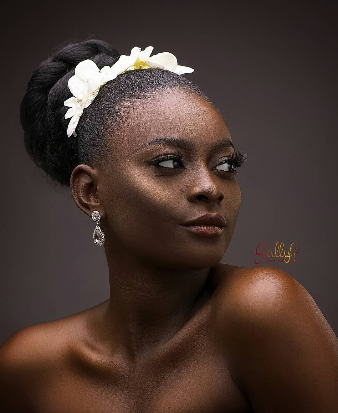 48. Ethereal Elegance: the Floral Crowned High Bun for Prom Queens