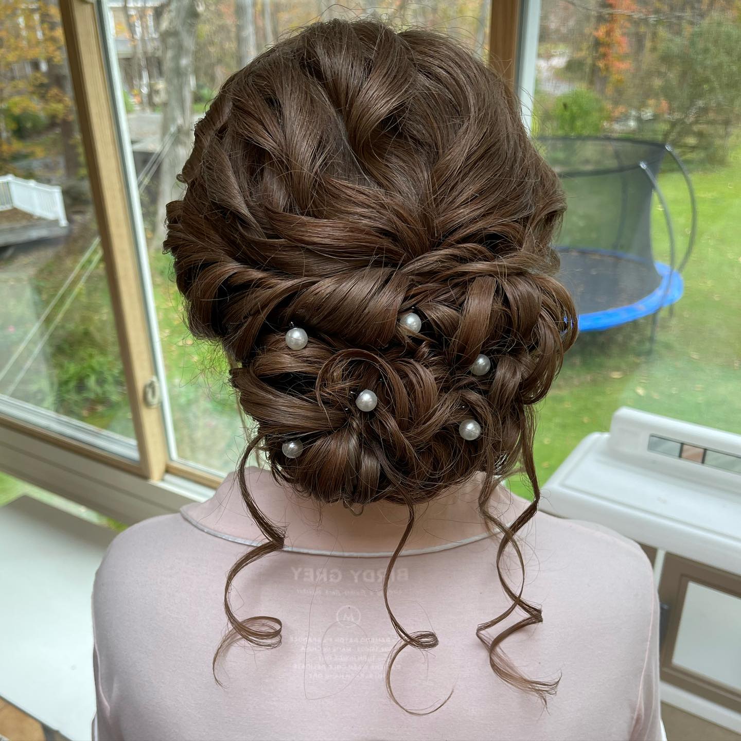 26. Whimsical Pearl-encrusted Chignon with Artful Twists