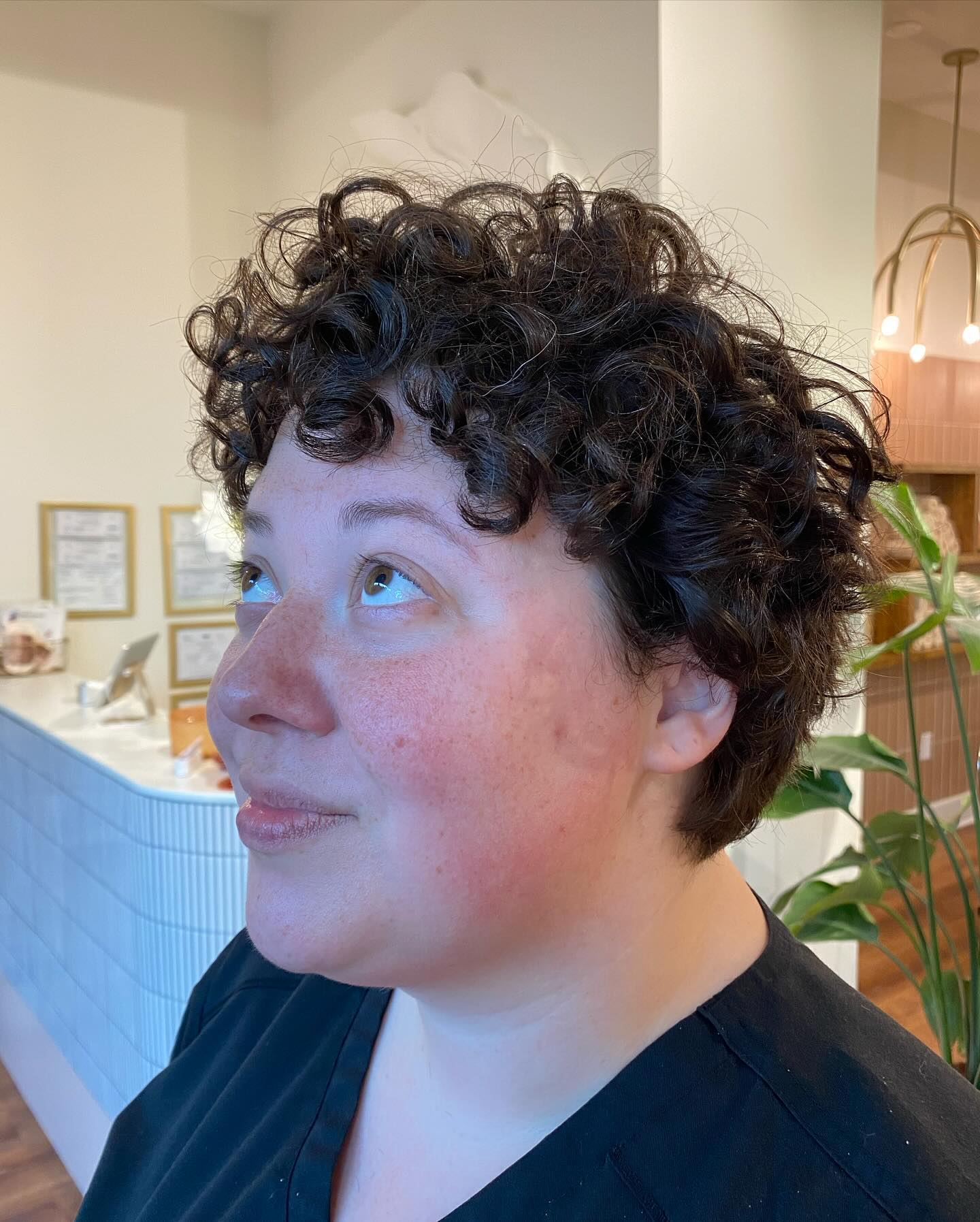 25. Curly Chic: Embrace the Playful Volume Of Baby Curls with Bold Bangs