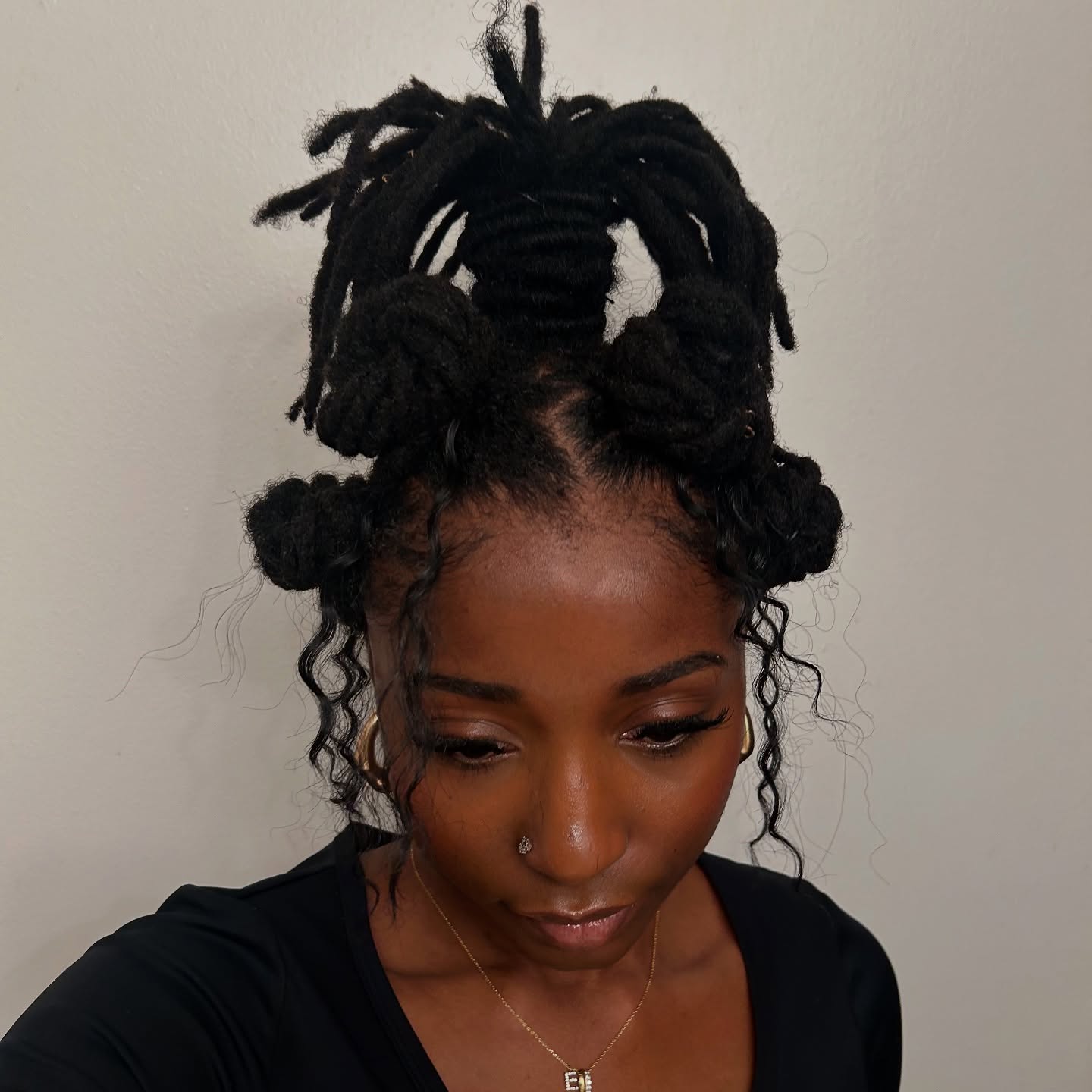 18. Twisted Abundance: the Playful Bun-updo with Free-spirited Waves