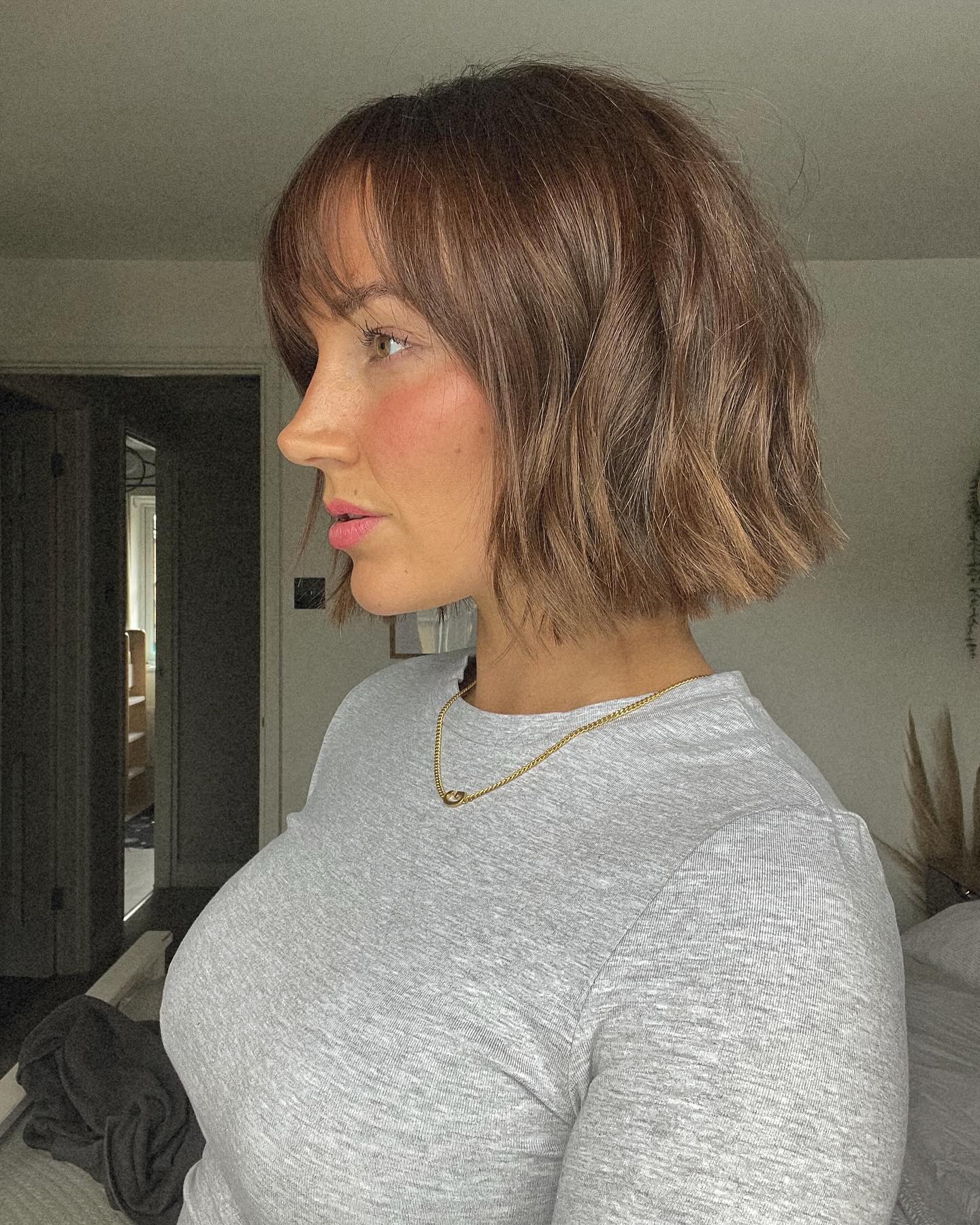 18. Bob Haircut with Textured Waves and Bangs