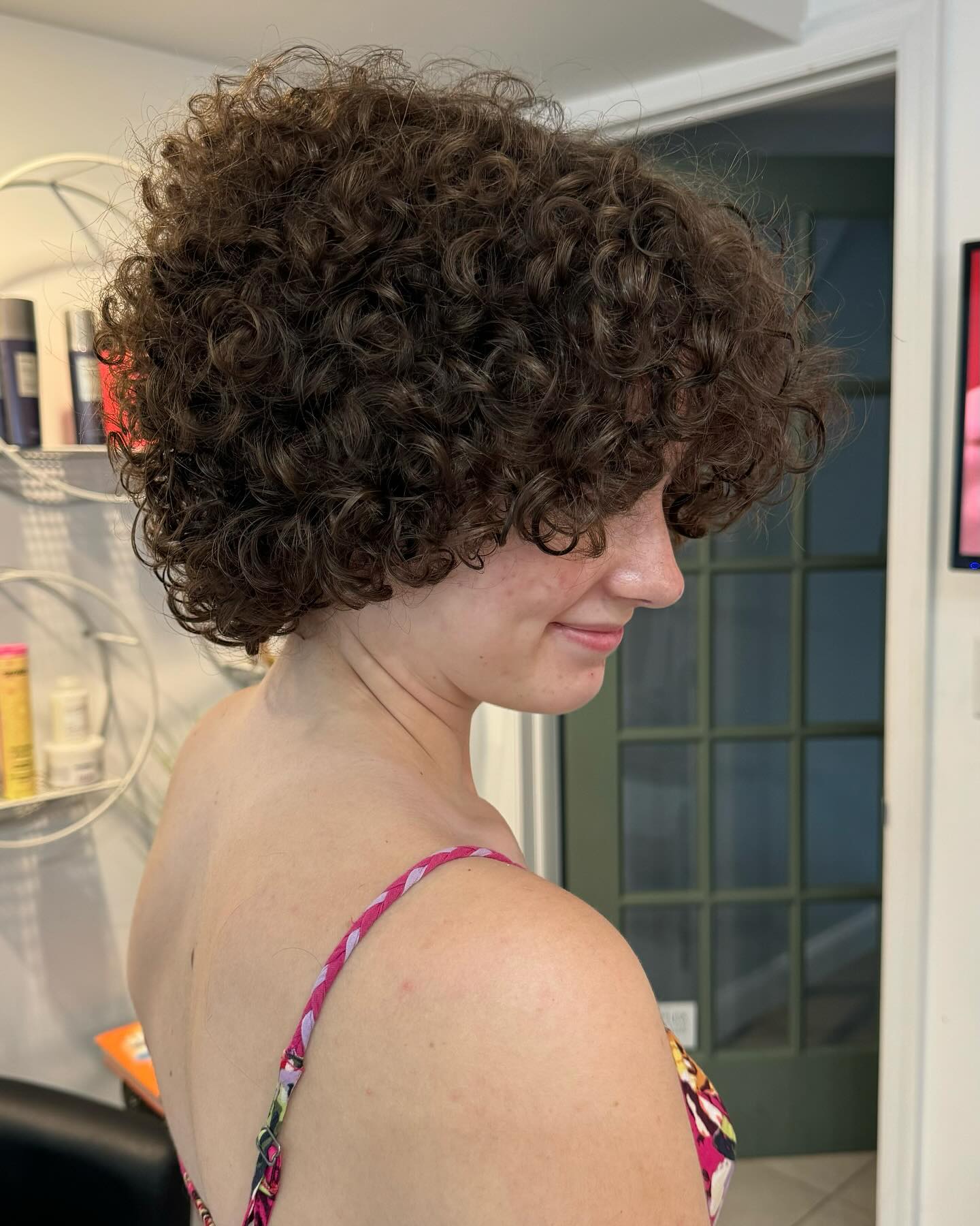 24. Curly Cotton Candy Bliss: a Playful Short 'do with Bangs