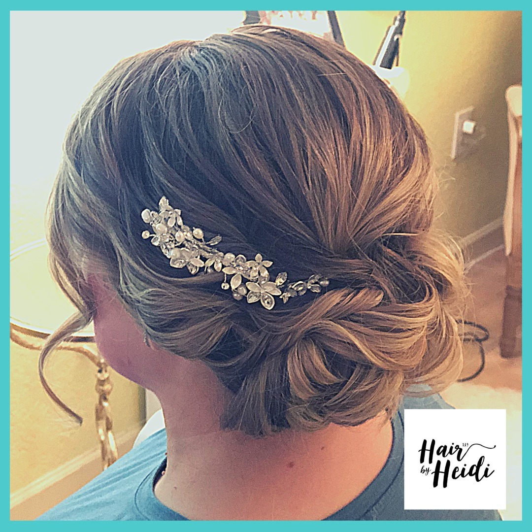 25. Whimsical Elegance: the Twisted Floral Updo for the Modern Bridesmaid