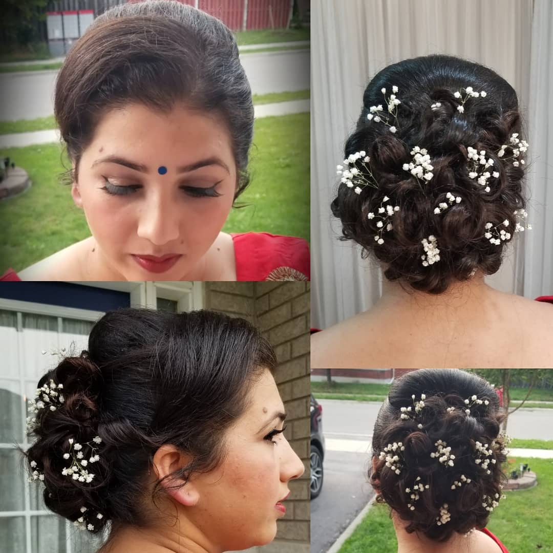 11. Whimsical Elegance: a Chic Braided Bun Adorned with Baby’s Breath