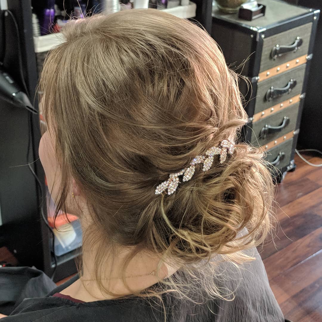 29. Twisted Elegance: a Dazzling Whimsical Updo for Effortlessly Chic Bridesmaids
