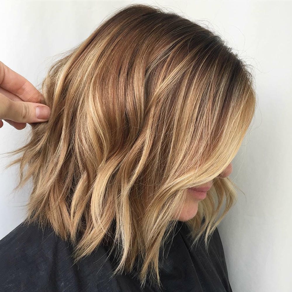 6. Textured Wavy Bob with Warm Highlights