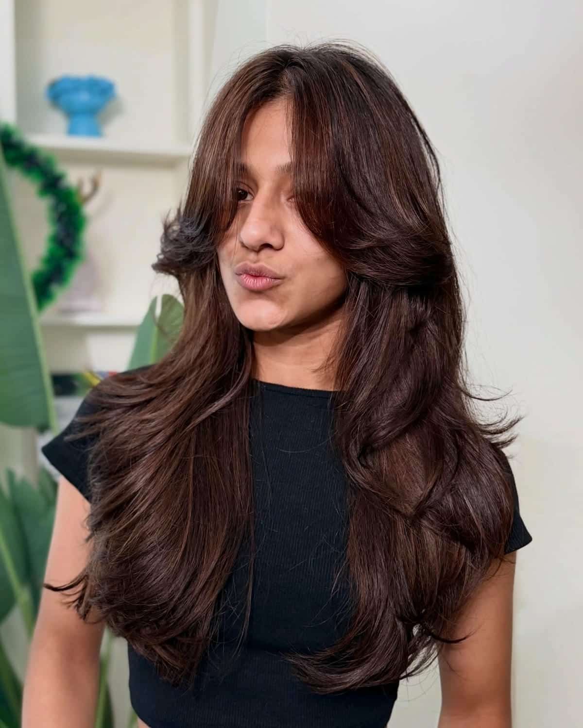 55. Layered Chocolate Brown with Face-Framing Bangs