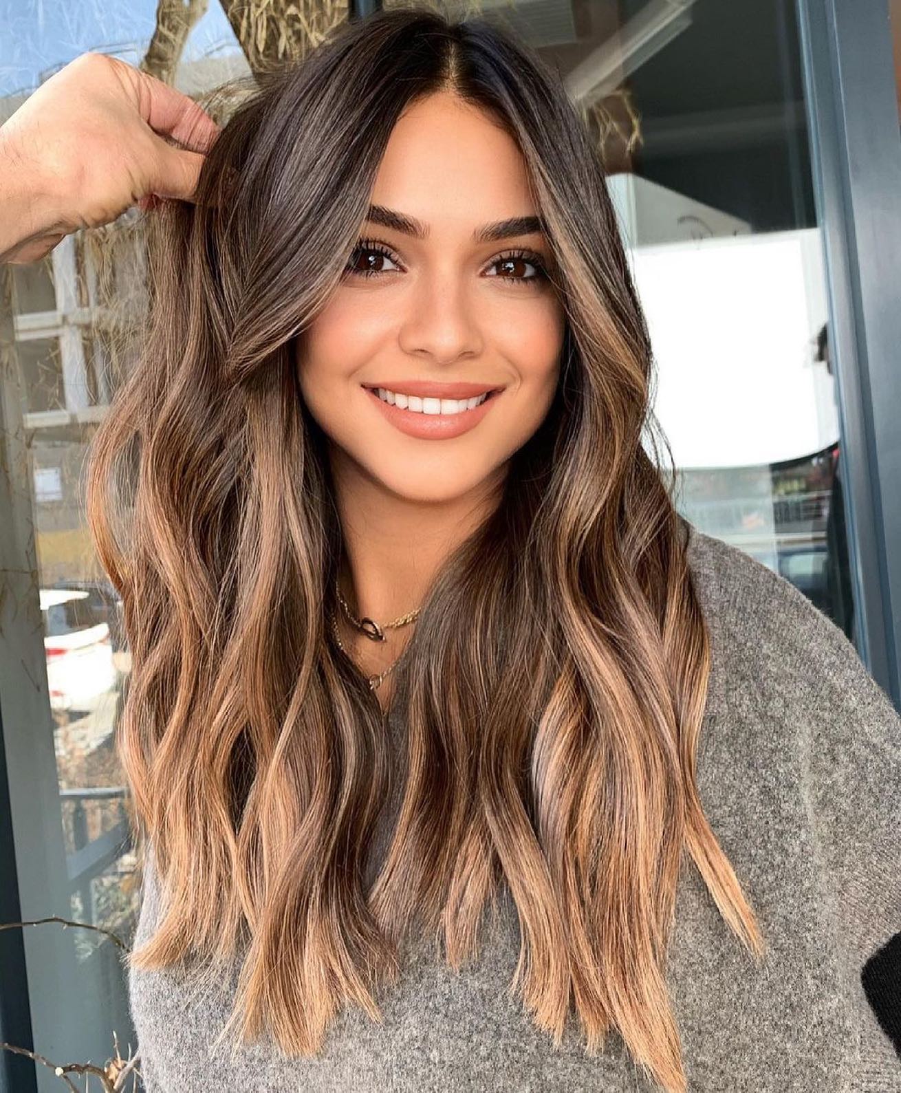 30. Sun-Kissed Dark Brown Waves with Caramel Highlights