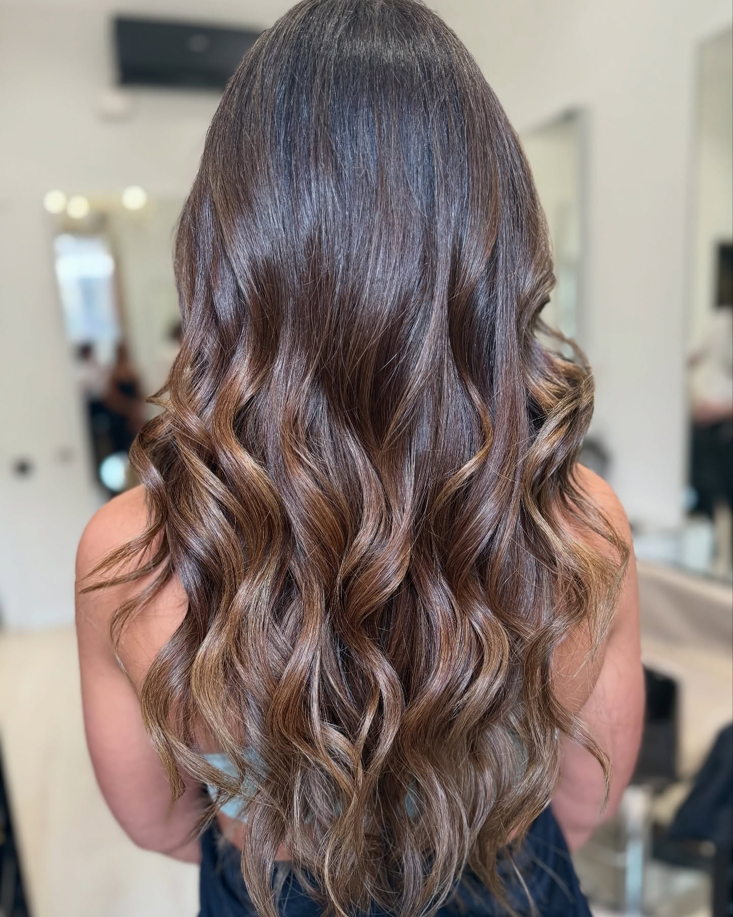 12. Lush Chocolate Waves with Honey Highlights