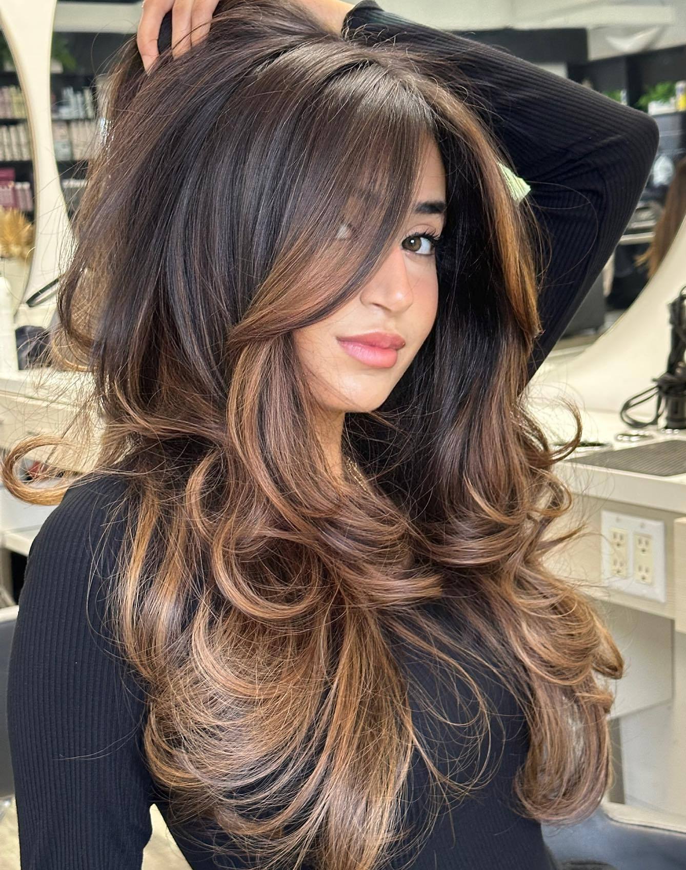 27. Layered Dark Brown Hair with Caramel Highlights