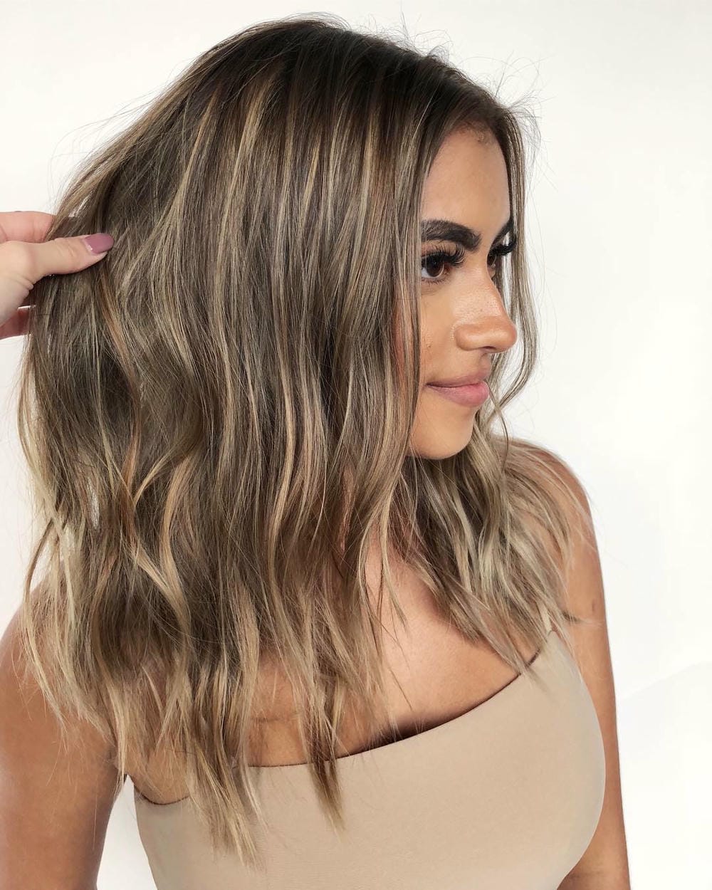 15. Effortlessly Wavy Light Brown Hair with Sun-Kissed Highlights