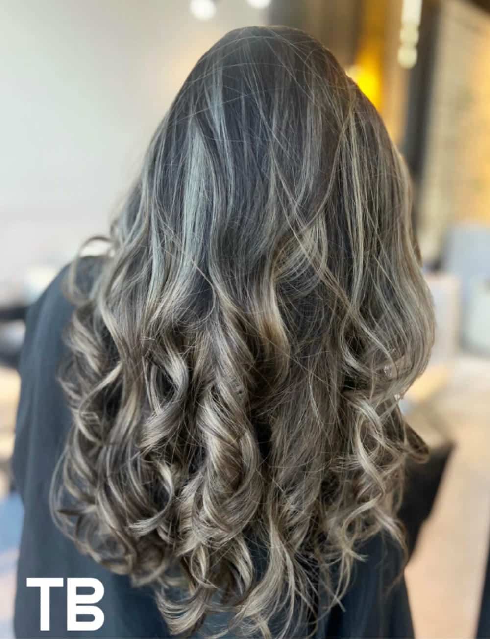 57. Title: Layered Light Brown Curls with Highlighted Dimensions