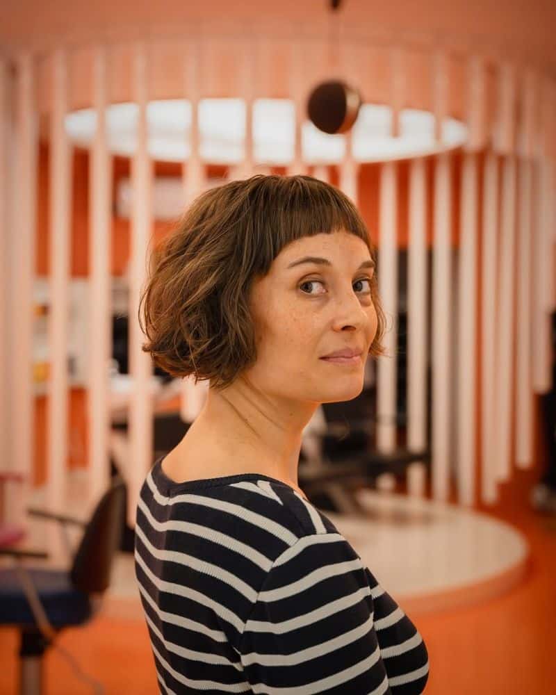 59. Curly Bob with Blunt Bangs