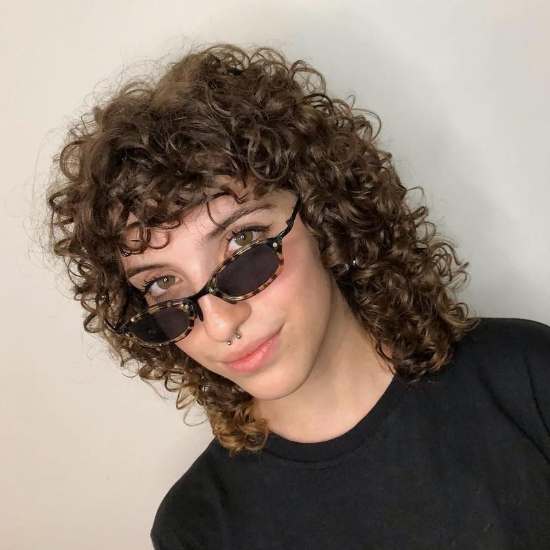 64. Curly Bob with Face-Framing Bangs