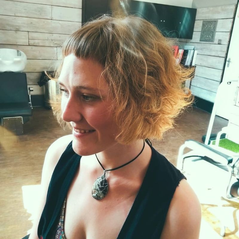 4. Curly Bob with Textured Bangs