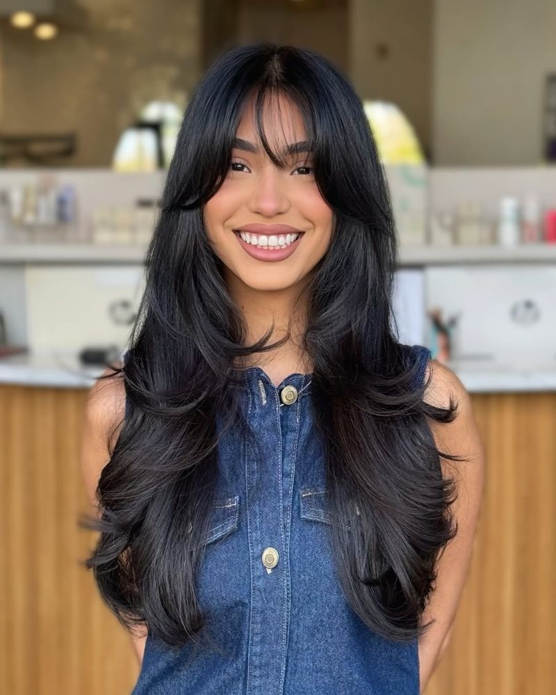 10. Long Layered Cut with Soft Bangs