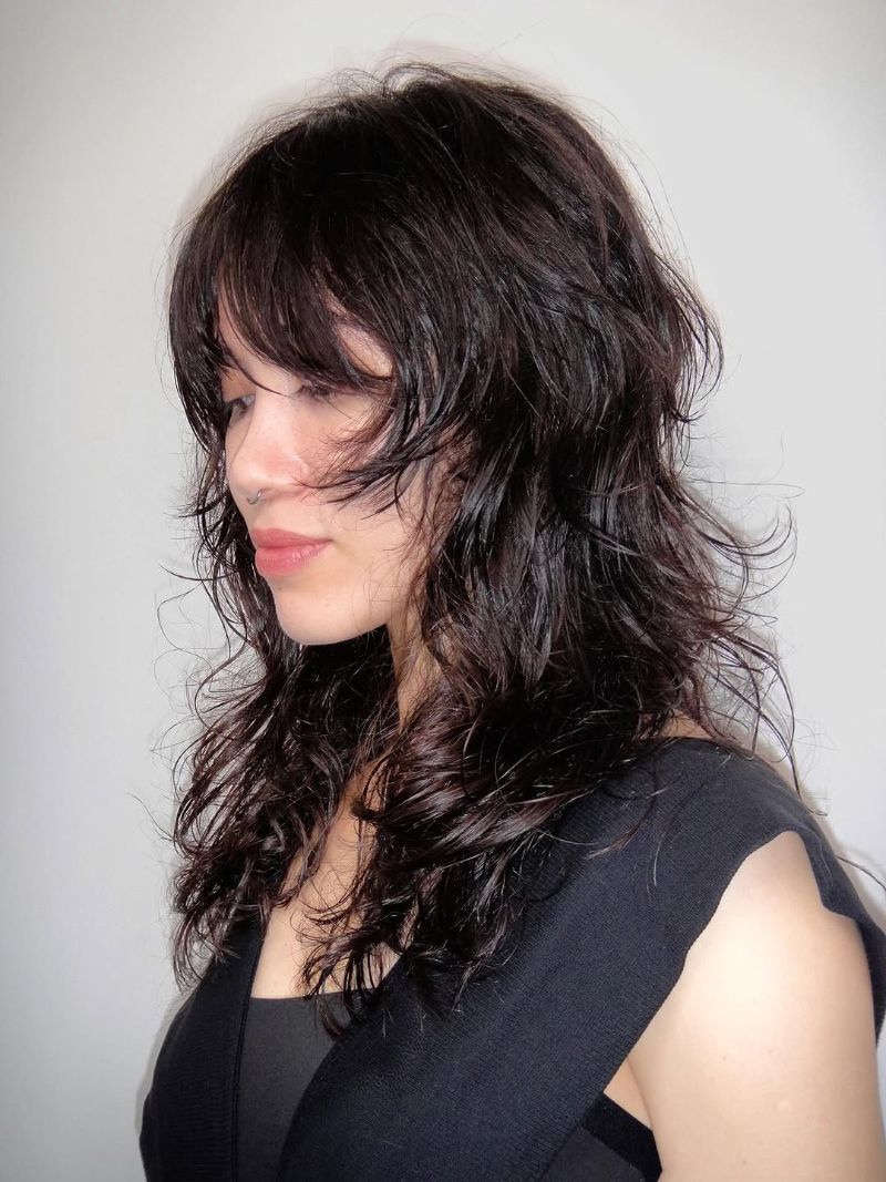27. Long, Textured Curls with Soft Bangs