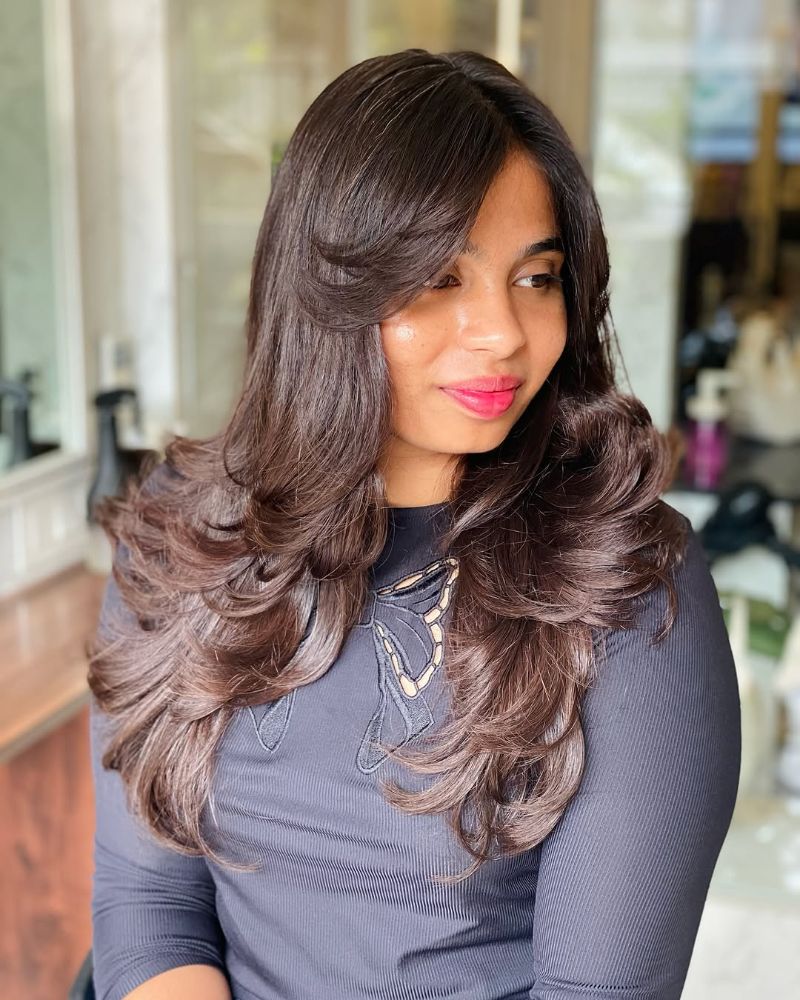 9. Long, Voluminous Layers with Soft Bangs