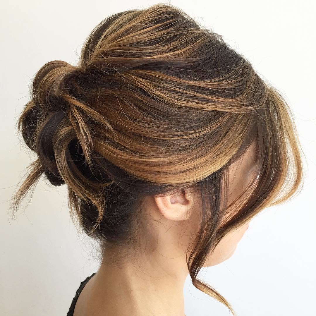 35. Messy Twisted Bun with Face-Framing Layers