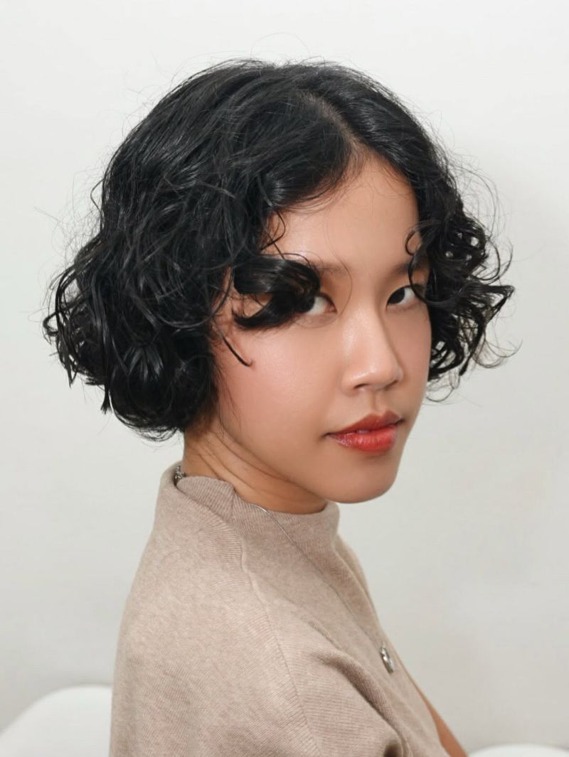 41. Textured Curly Bob with Face-Framing Tendrils