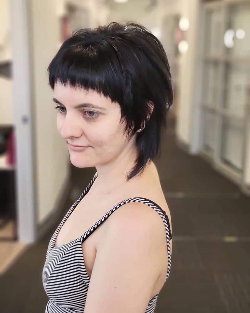 13. Edgy Textured Pixie with Bold Bangs
