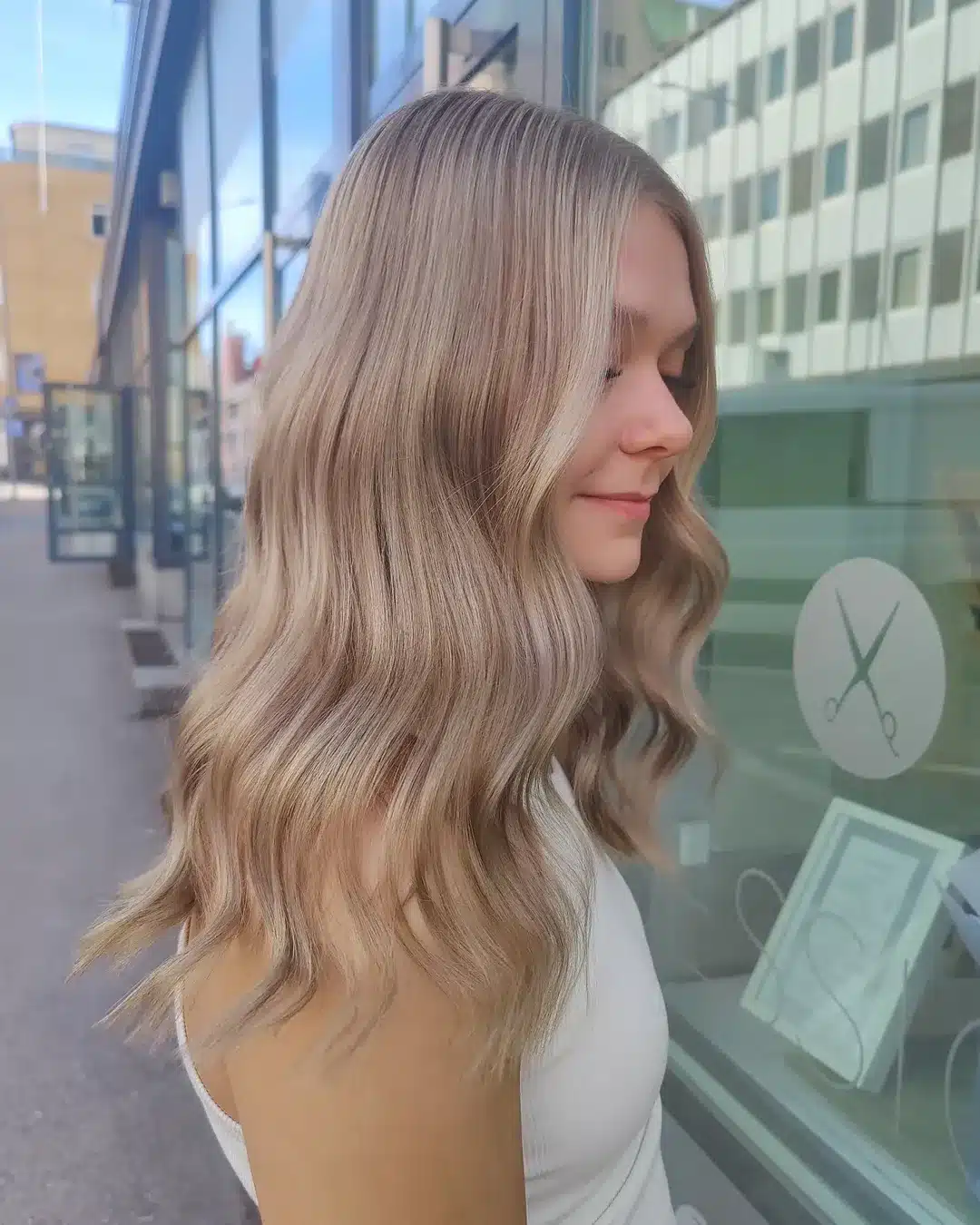 47. Ash Blonde Waves with Face-Framing Highlights