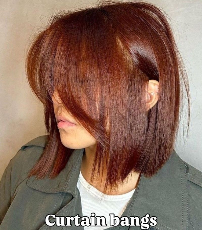 50. Auburn Blunt Bob with Sweeping Curtain Bangs