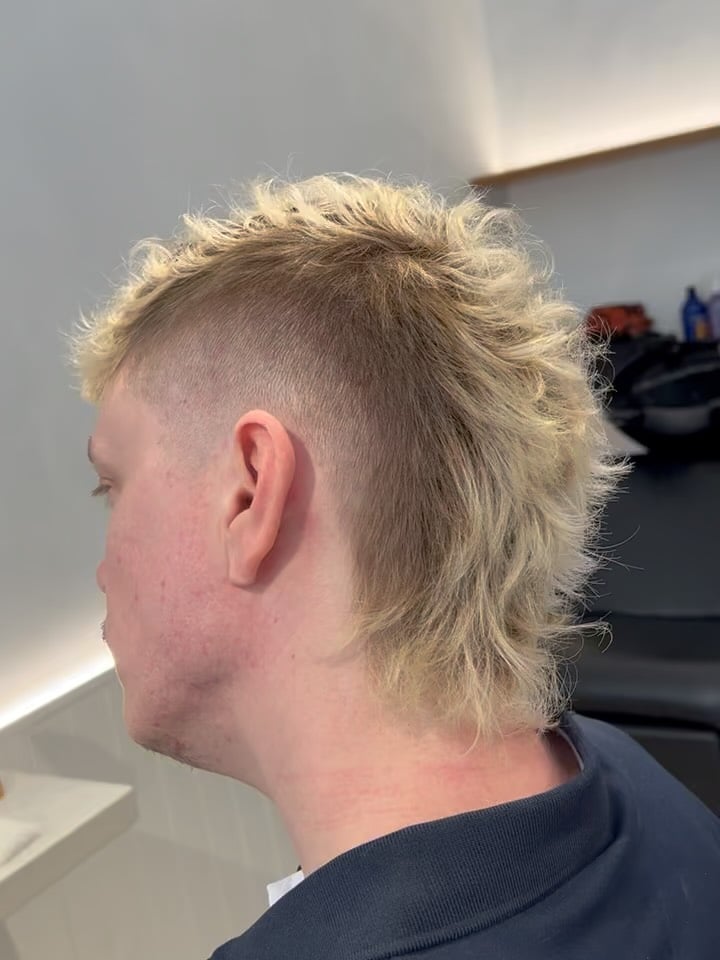 10. Bleached Curly Mullet with Skin Fade