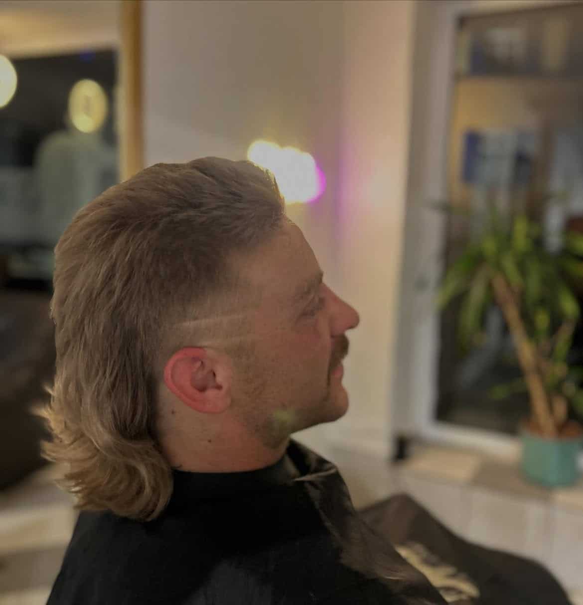 4. Blonde Burst Fade Mullet with Hard Part