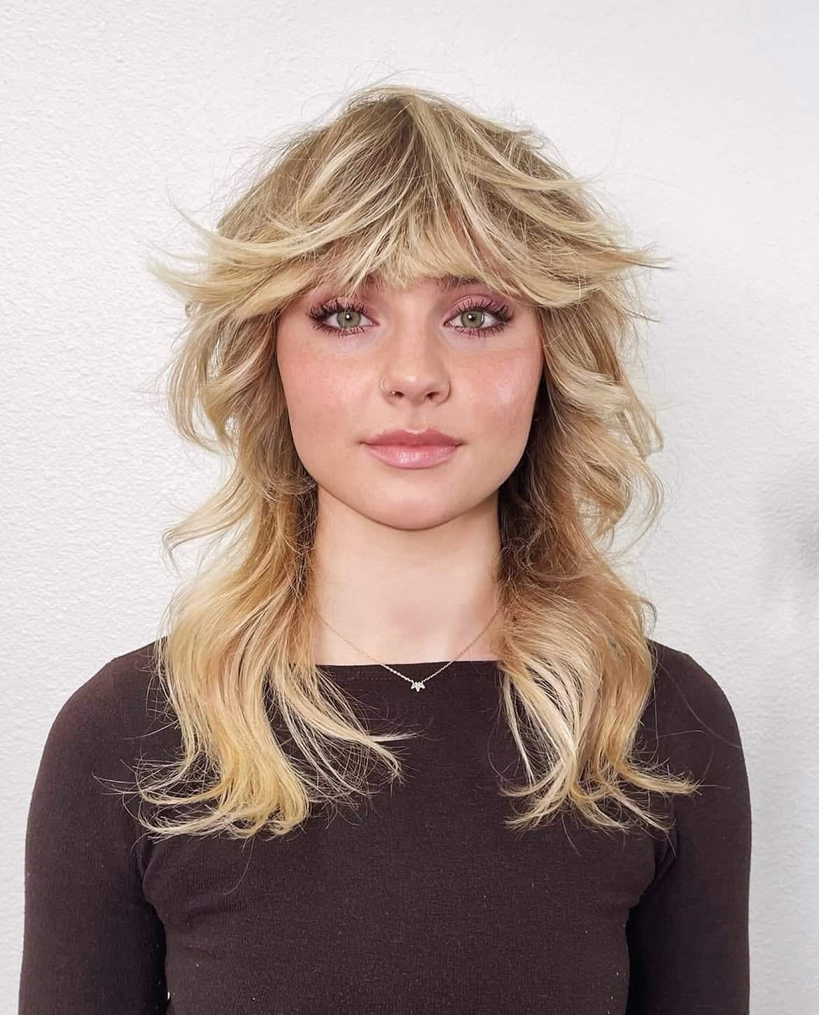 24. Blonde Feathered Shag Mullet with Wispy Bangs