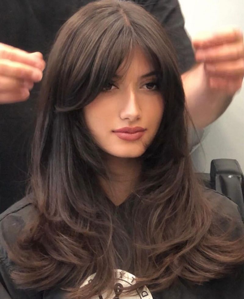 22. Blowout Layers with Heavy Curtain Bangs