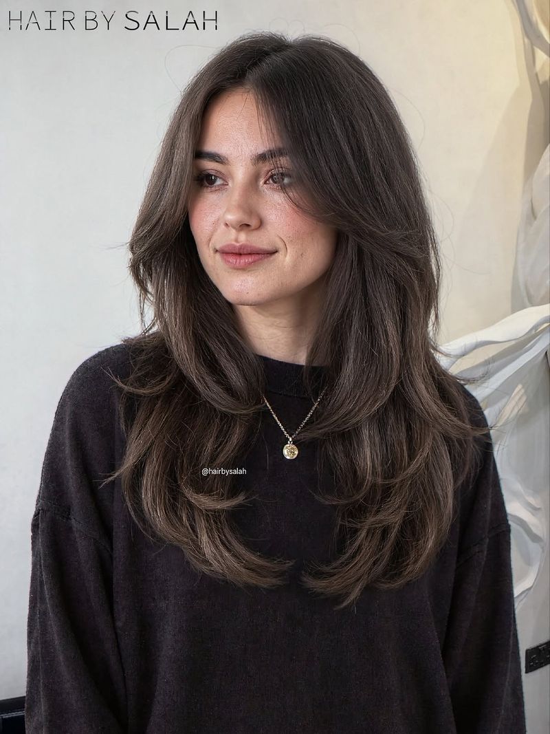 6. Blowout Layers with Soft Chestnut Curtain Bangs
