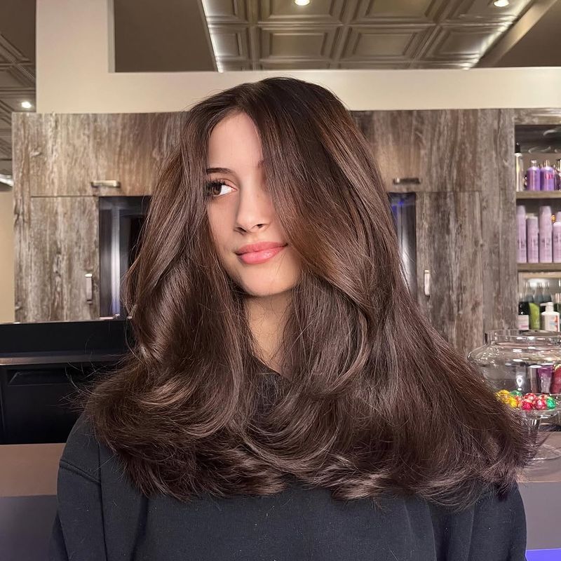4. Blowout Layers with Soft Curtain Bangs