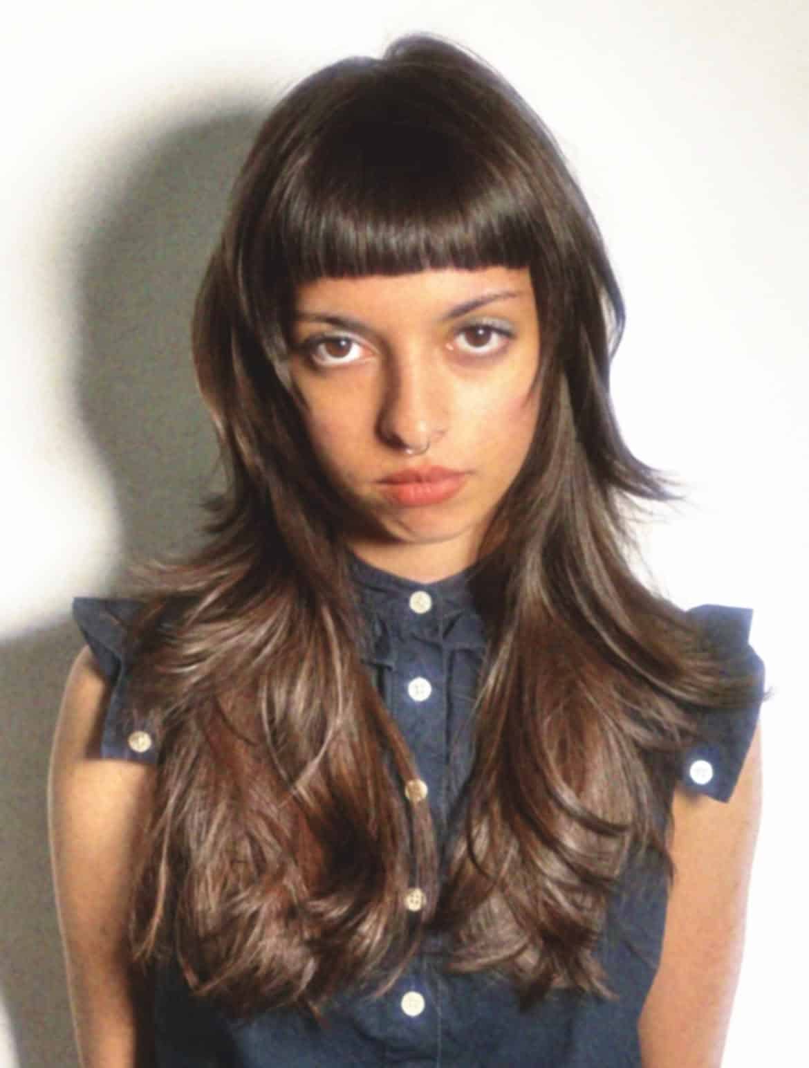 26. Blunt Micro Bangs with Feathered Layers