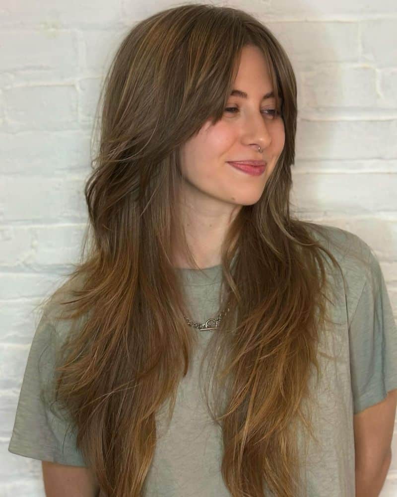 2. Caramel Highlights with Curtain Bangs