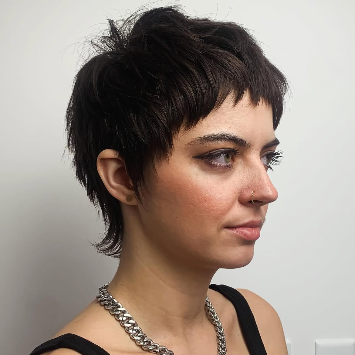 41. Choppy Brunette Pixie Mullet with Micro Bangs
