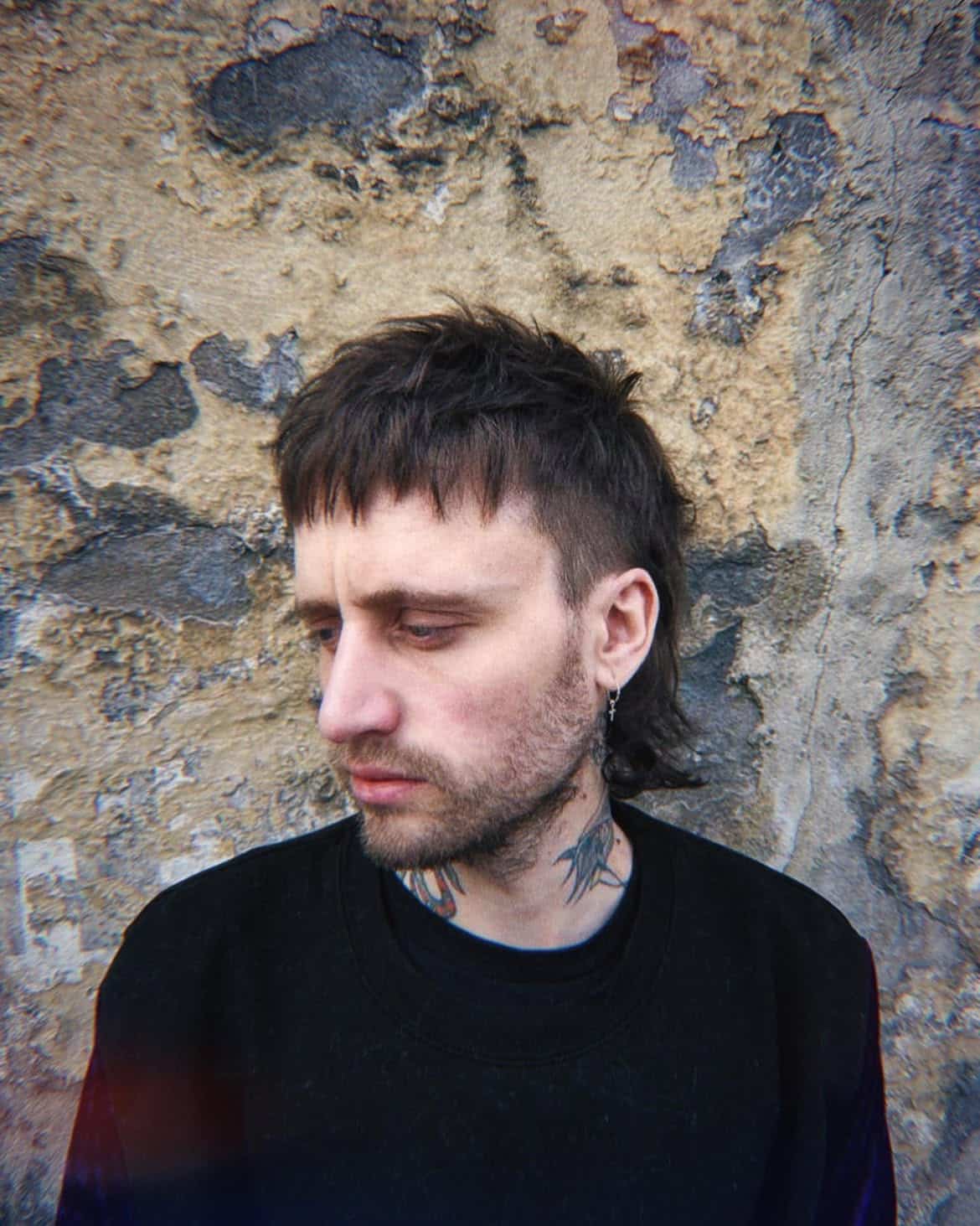 7. Choppy Micro-Fringe Mullet with Tapered Sides
