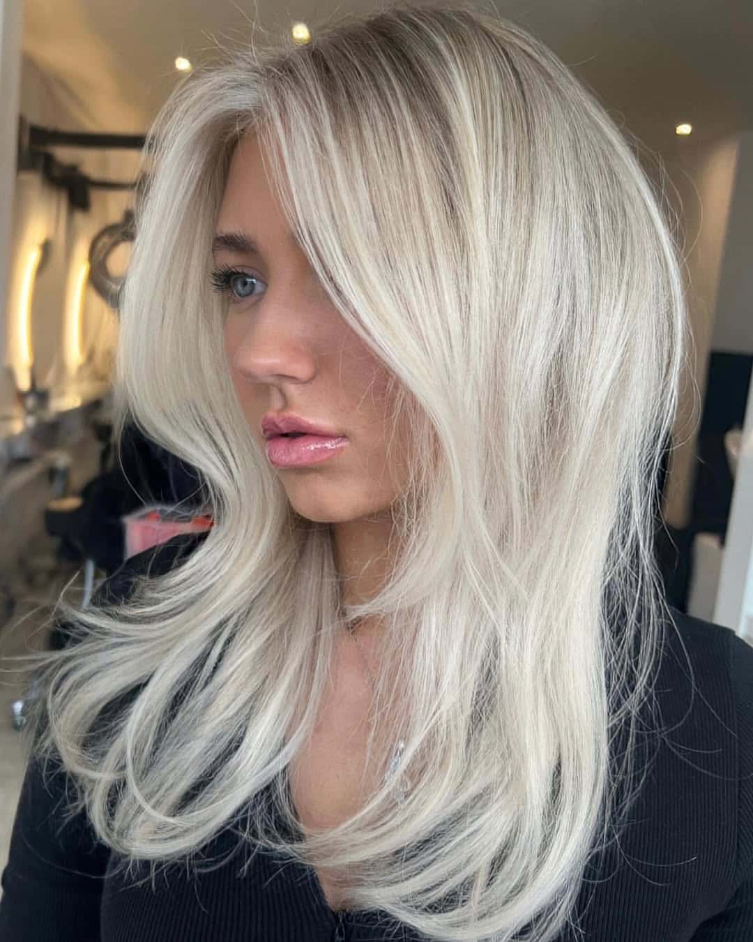 39. Creamy Blonde Butterfly Layers with Heavy Curtain Bangs